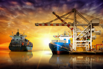 Naklejka premium Cargo ship carrying container import and export goods stand by in the cargo yard port concept freight shipping ship.