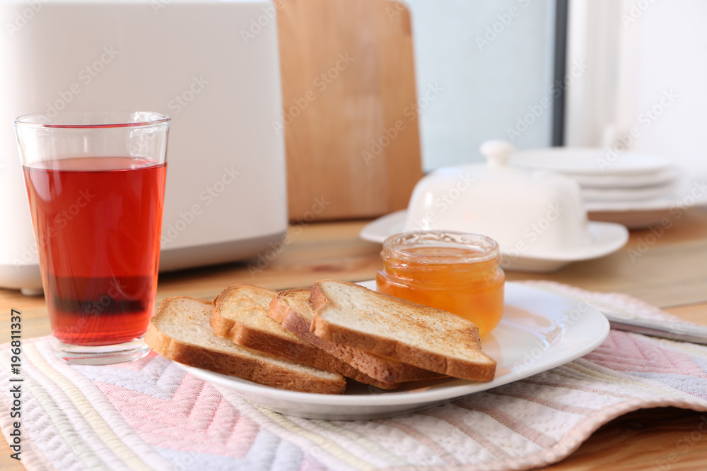 Sticker plate with toasted bread and jam on table