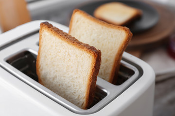 Slices of bread in toaster, closeup