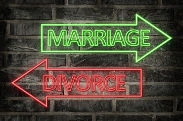 Fototapeta premium illustration of neon signs on a brick wall of an arrows with marriage and divorce text