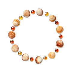 Pattern of shells and orange glass beads in the shape of a circle. Frame or design element. isolated on white background