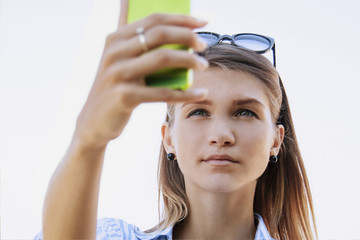 Self-time. Portrait of selfie addict happy young woman