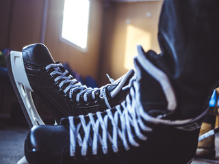 close up hockey player ice skates in the locker room