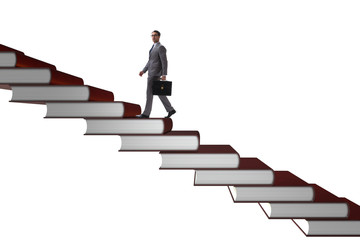 Businessman student climbing the ladder of education books