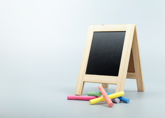 chalkboard, blackboard stand with chalk on clean background.