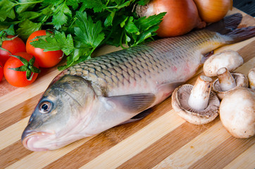 Uncooked fish on cutting board in meal preparation concept