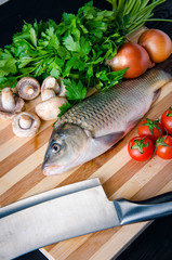 Uncooked fish on cutting board in meal preparation concept