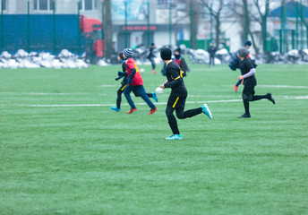 Obraz premium boys play football on the winter stadium