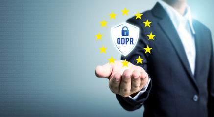 Businessman hand holding sign general data protection regulation (GDPR) and shield with key icon