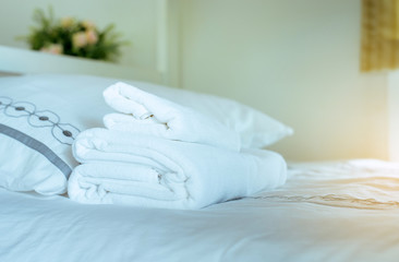 White towel on bed,Stack of plush hotel towels