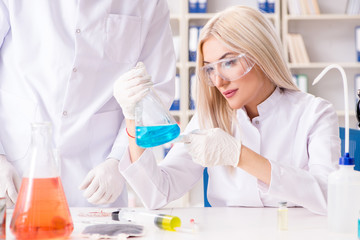 Young woman chemist working in clinic lab