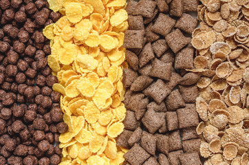 background of mixed breakfast cereal (chocolate balls, corn, grain, chocolate pads), top view - 196820932