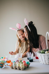 Mother and Daughter Painting Easter Eggs together