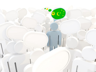 Obraz premium Man with flag of cocos islands in a crowd