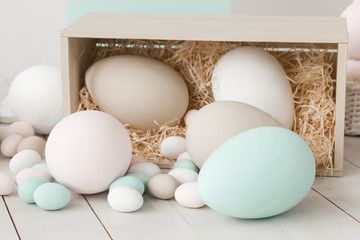 Easter eggs in wooden box with straw