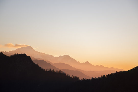 sunset throuh alpine mountin layers
