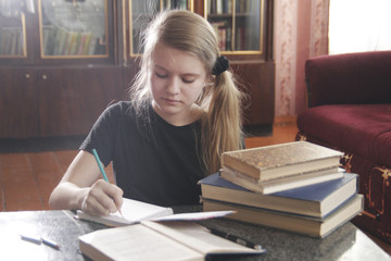 Portrait of a girl teen doing lessons at home