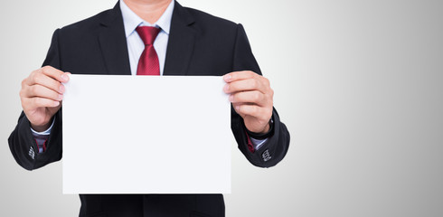 Businessman holding blank white paper