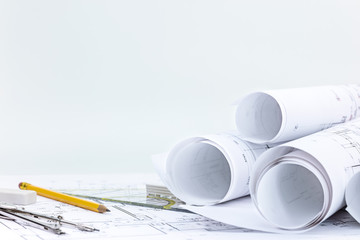 engineering tools, roll blueprints and architectural project plans on wooden desk  