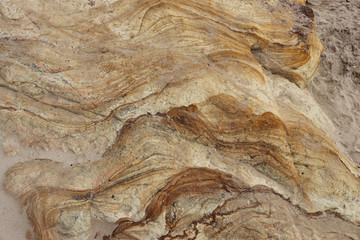 patterned and textured rock formationon on a beach