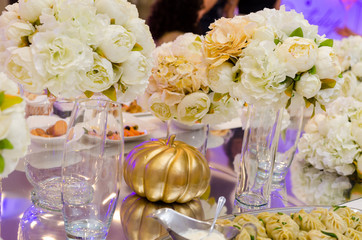 Golden pumpkin decoration with the yellow flowers