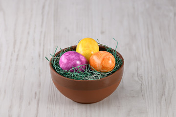 easter eggs in basket on a wooden background