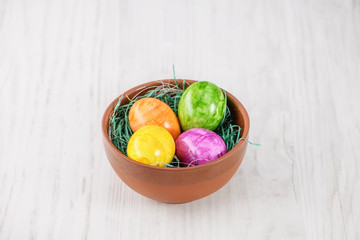 easter eggs in basket on a wooden background