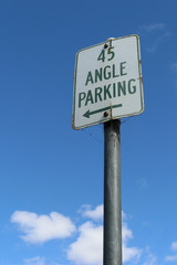 green and white 45 degree Angle Parking sign in a blue sky