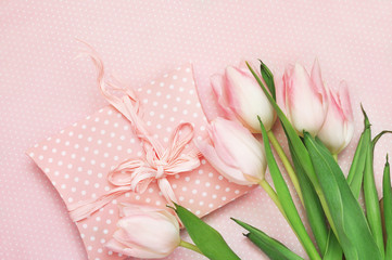 Spring blossoming tulips, festive gift on flower background, pastel and soft floral card, selective focus, toned