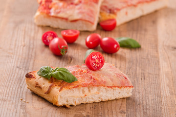 Italian pizza with cheese, tomatoes and fresh basil. 