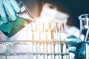 Scientist with equipment holding tools during scientific experiment science concept
