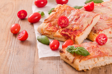 Italian pizza with cheese, tomatoes and fresh basil. 