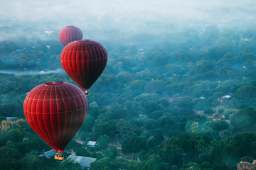 Red balls in the morning in the fog above Bagan. Bagan  is an ancient city located in the Mandalay Region of Myanmar