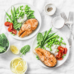 Healthy balanced mediterranean diet lunch - baked salmon, rice, green peas and green beans on a light background, top view. Flat lay