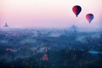 Red balls in the morning in the fog above Bagan. Bagan is an ancient city located in the Mandalay Region of Myanmar