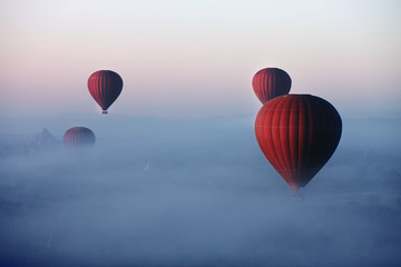 Red balls in the morning in the fog above Bagan. Bagan is an ancient city located in the Mandalay Region of Myanmar