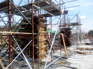 Column timber form work and reinforcement bar at the construction site in Malacca, Malaysia. The structure supported by temporary wood support