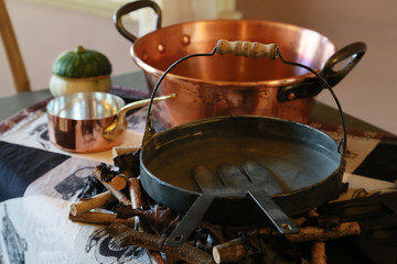 Spectacle of cooking utensil pot and frying pan in the kitchen in the room