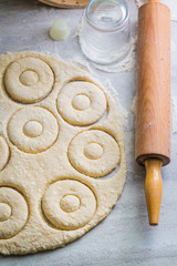 Preparation for baking sweet homemade donuts on gray table