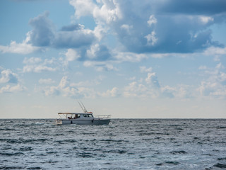 sport fishing boat in the sea. beautiful cloudy sky
