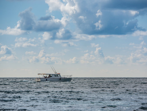 Sport Fishing Boat In The Sea. Beautiful Cloudy Sky