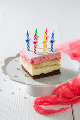 Tasty birthday cake with strawberry and candles
