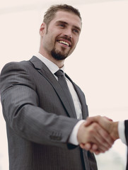 closeup .businessman shaking hands with a business partner.