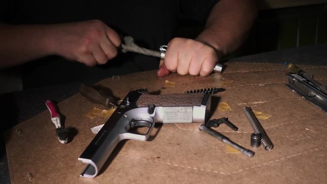 Firearm dis-assembly for cleaning and safety check of handheld gun. 