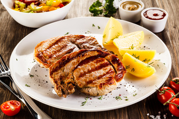 Grilled steak, boiled potatoes and vegetable salad 