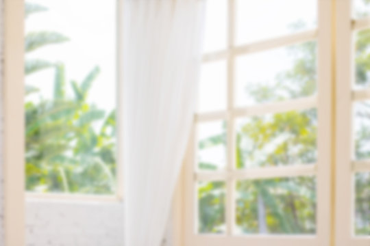 Fototapeta Defocused window background with white curtains in morning time.