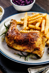 Grilled chicken legs with French fries and vegetables