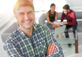 Fototapeta premium Smiling mature businessman in plaid shirt foreground