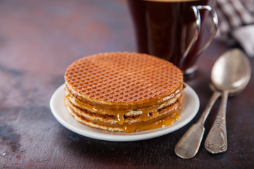 Wafers with caramel and coffee on a table. Selective focus. Copy space.
