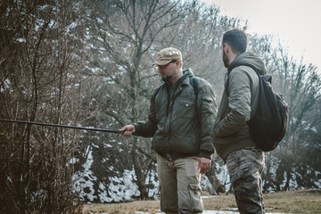 Naklejka premium Two men talking and fishing.